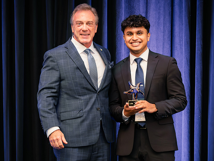 Pharm.D. student Jeremy Ninan accepts the Glenda Lawson McRee Pharmacy Student Award on behalf of Pharm.D. candidate Megan Huang Frazier.