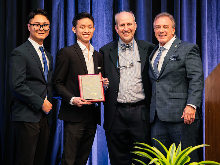 Wallace, and Lim accept award from Reich