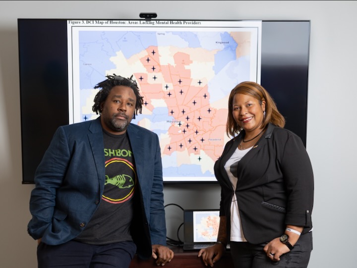 Carmack and Kelly posing by map