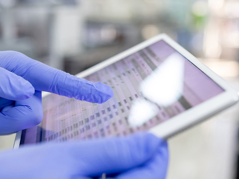 lab scientist holding tablet