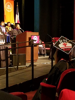 An african-american woman standing behind a podium on a stage