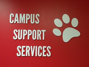 Photograph of Campus Support Services sign on a red wall