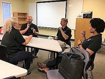 Four people stitting around a table