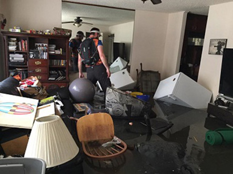 Person walking through a room filled with debris