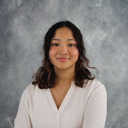 Portrait of a Southeast Asian woman with wavy shoulder-lenght hair