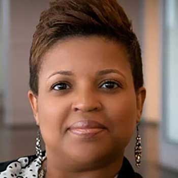Portrait of Black woman with brown hair in a short pixie cut