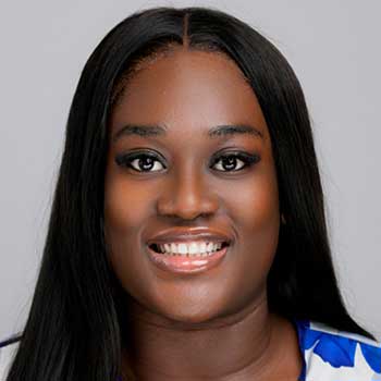 Portrait of a Black woman with long straight hair smiling