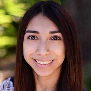 Portrait of a Hispanic woman smiling with long dark hair