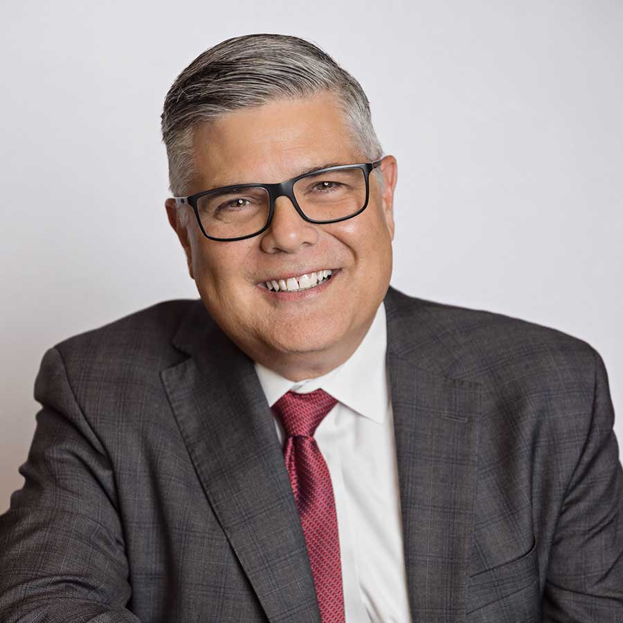 Portrait of Dr. Jay Neal smiling wearing a suit