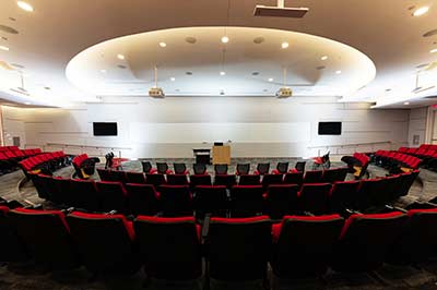 A small tiered semi-circular auditorium with a podium at the center.