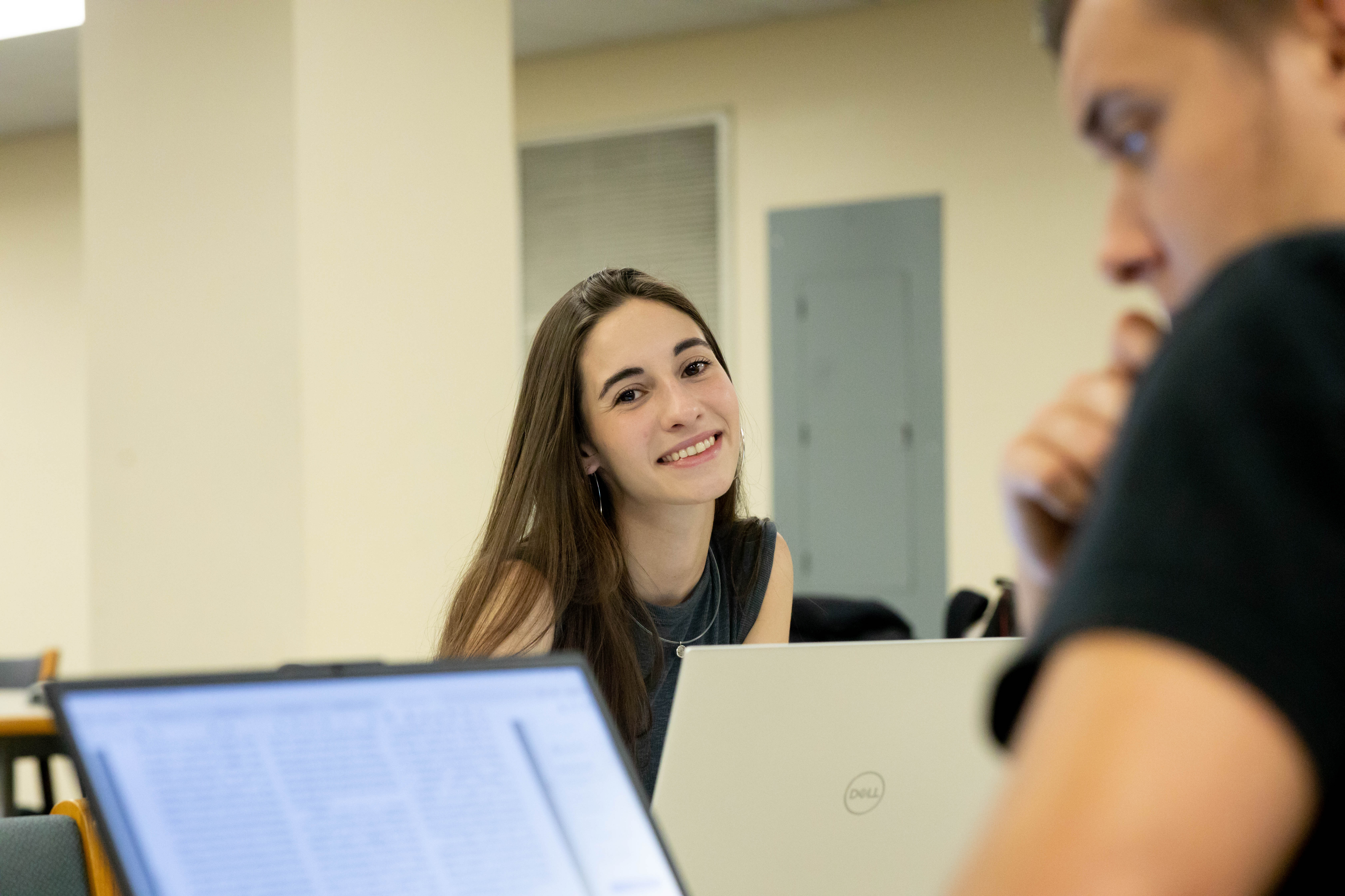 a smiling female student on campus